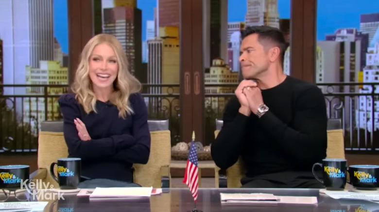 Kelly Ripa and Mark Consuelos hosting their show