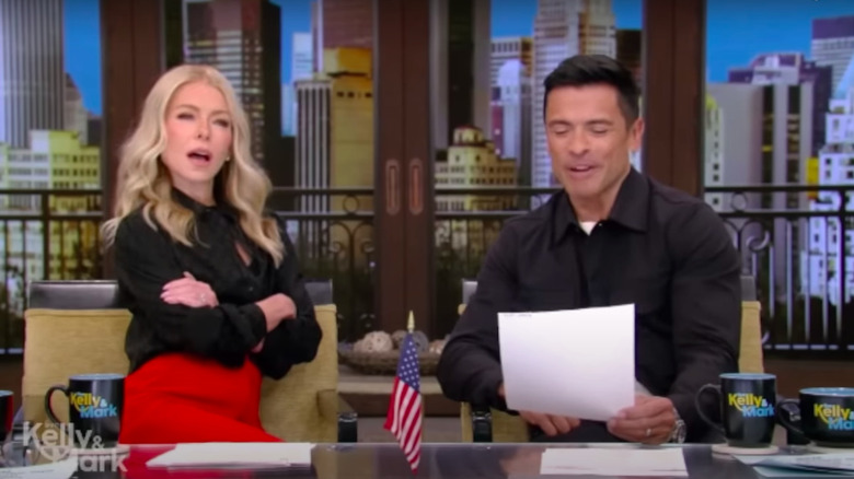 Kelly Ripa shocked while Mark Consuelos reads