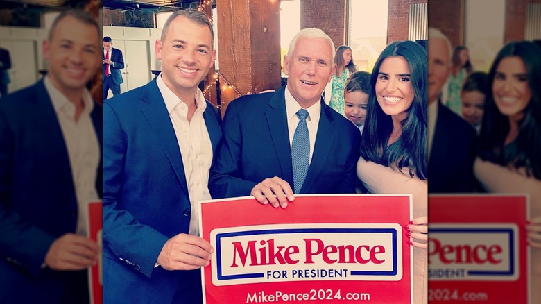 John, Mike, and Giovanna Pence hold Pence presidential campaign poster