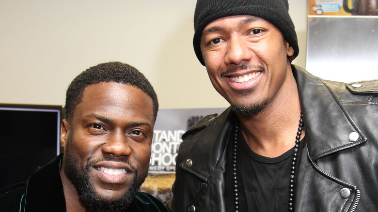 Kevin Hart and Nick Cannon standing next to each other smiling