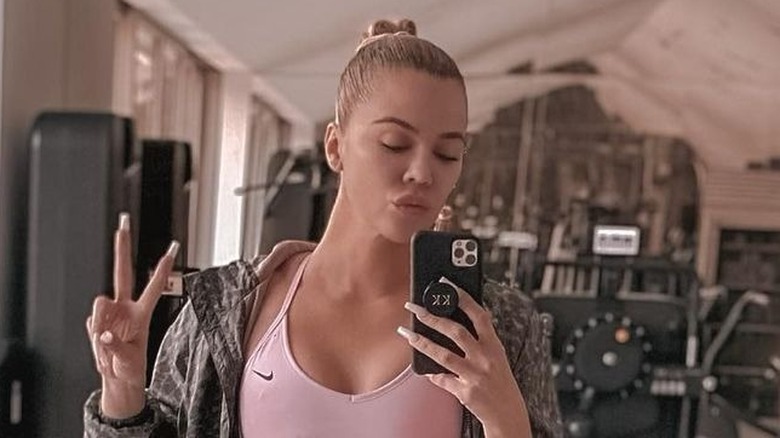 Khloé Kardashian poses in the gym