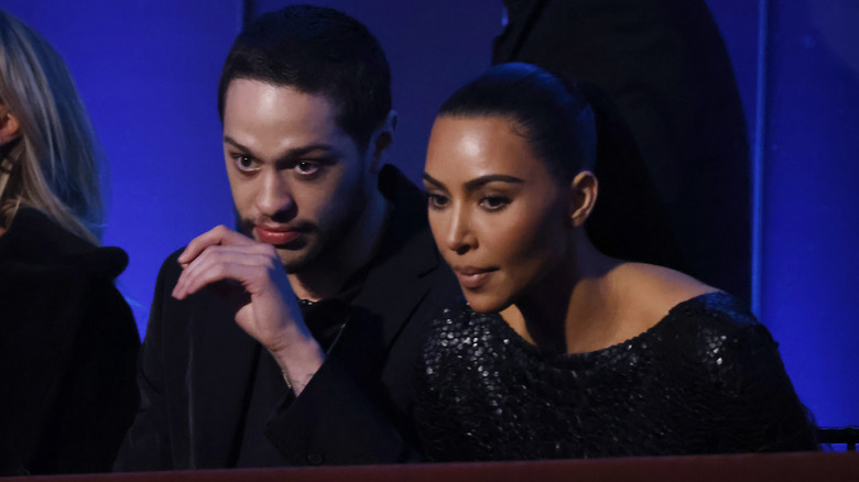 Pete Davidson and Kim Kardashian sitting together 