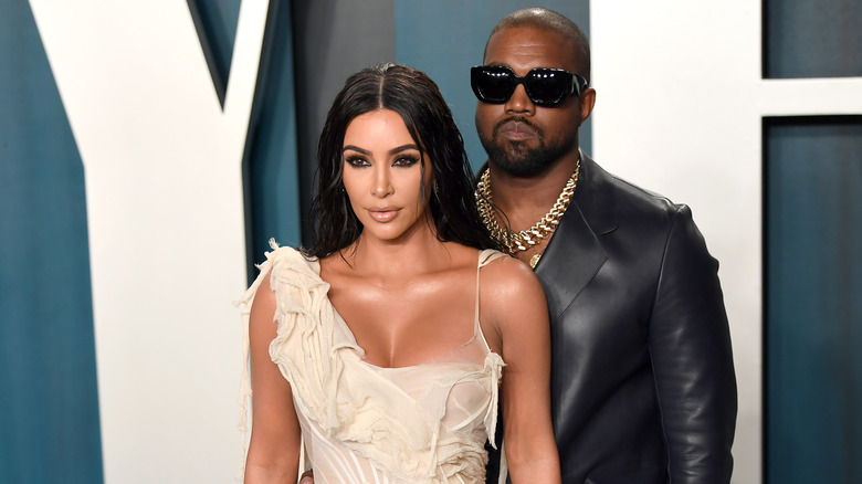 Kim Kardashian and Kanye West posing on red carpet