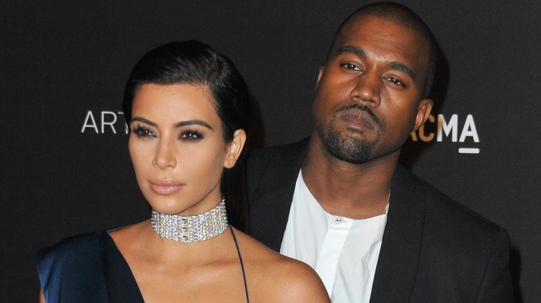 Kim Kardashian and Kanye West looking serious at an event