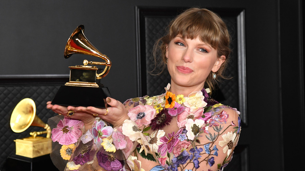 Taylor Swift holding a Grammy award