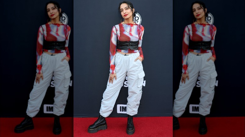 Woman in a tie-dye shirt and white pants