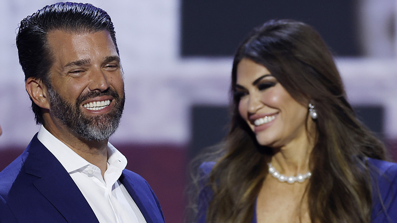 Donald Trump Jr. and Kimberly Guilfoyle in blue smiling