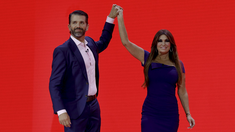 Kimberly Guilfoyle and Donald Trump Jr. clasping hands