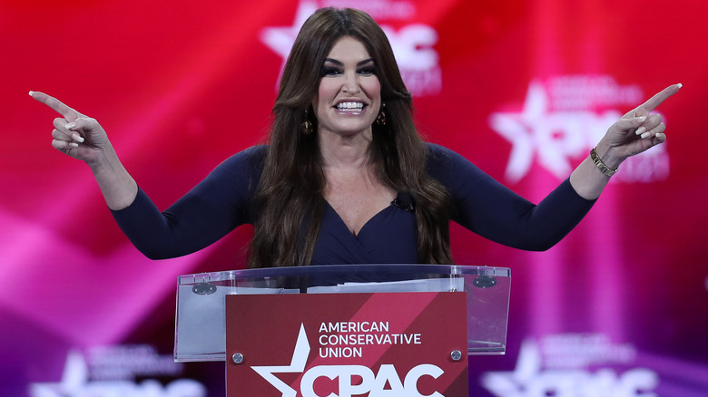 Kimberly Guilfoyle pointing both arms at CPAC