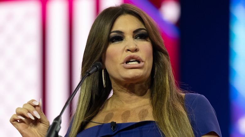 Kimberly Guilfoyle speaking at a podium, scowling