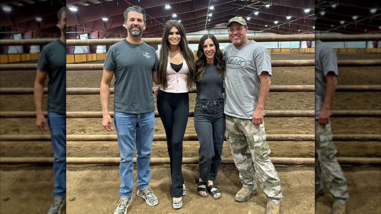 Kimberly Guilfoyle in tall sparkly heels posing with Don Jr and two others in a Utah barn