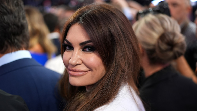 Close-up of Kimberly Guilfoyle smiling over her shoulder