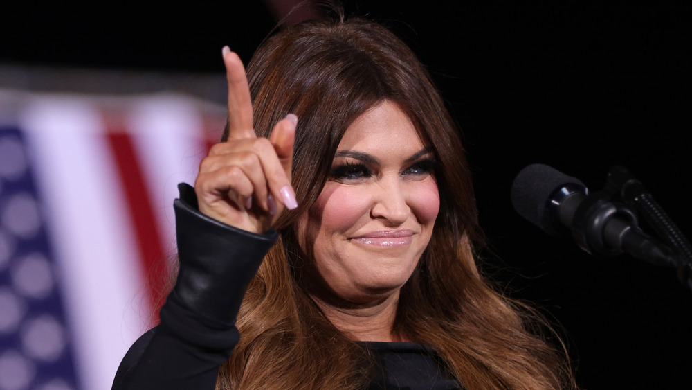 Kimberly Guilfoyle grinning holding up pointer finger