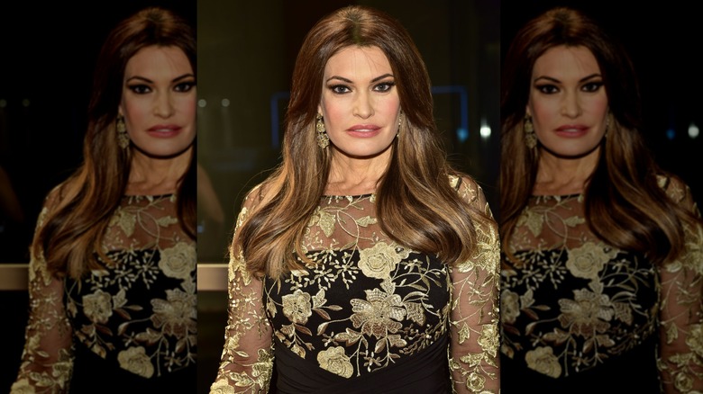 Kimberly Guilfoyle posing in black and gold dress