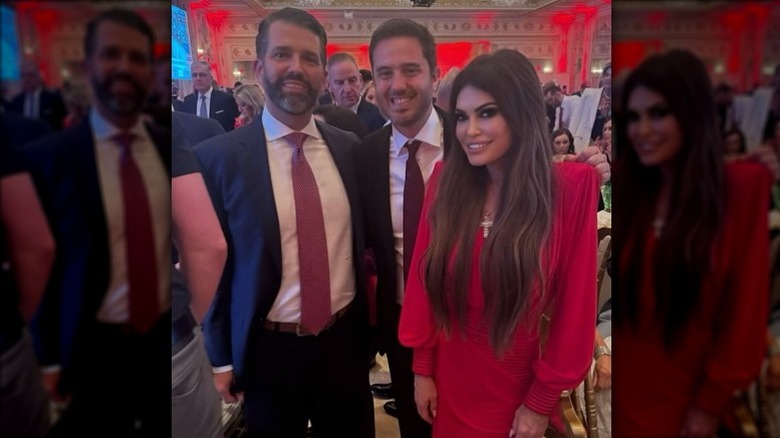 Chris Pavloski posing in between awkwardly posed Don Jr. and Kimberly Guilfoyle