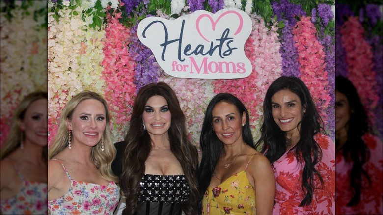 Kimberly Guilfoyle posing with attendees at the Hearts for Moms gala