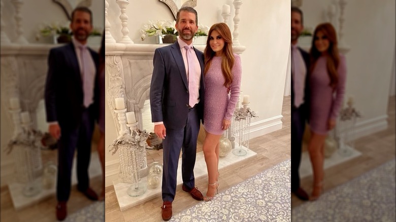 Kimberly Guilfoyle with Donald Trump Jr. posing by a fireplace