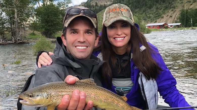 Donald Trump Jr smiling with Kimberly Guilfoyle while holding a fish