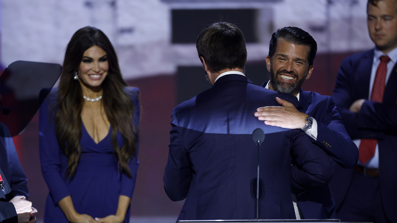 Kimberly Guilfoyle smiling behind Don Jr.