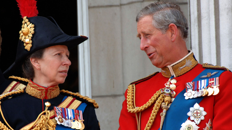 King Charles and Princess Anne chatting on Buckingham Palace balcony