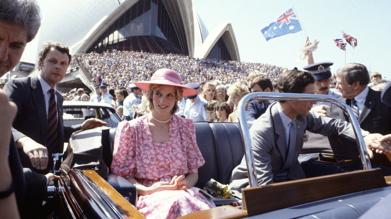 Princess Diana and King Charles greet a crowd