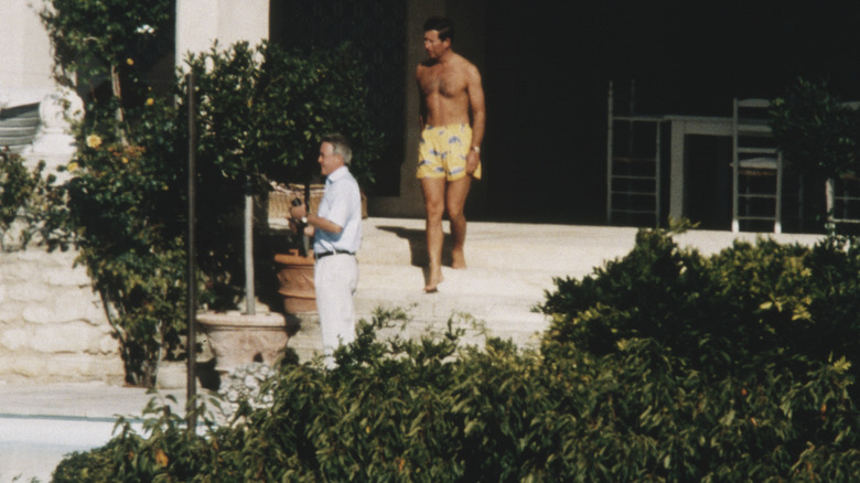 Young Prince Charles in swimming trunks on doorstep