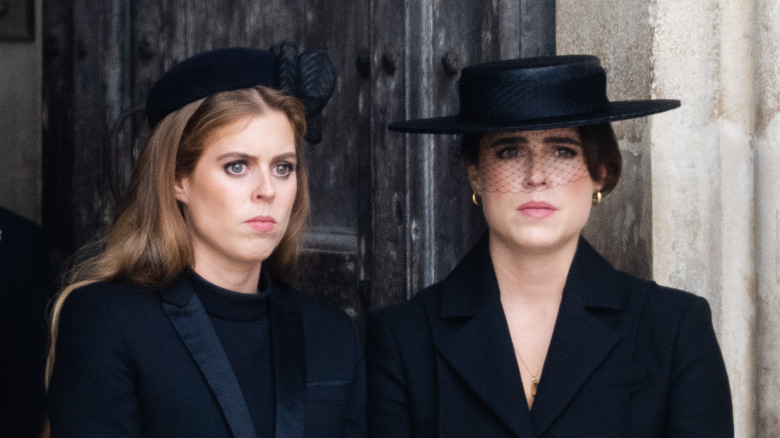 Princess Eugenie and Princess Beatrice frowning