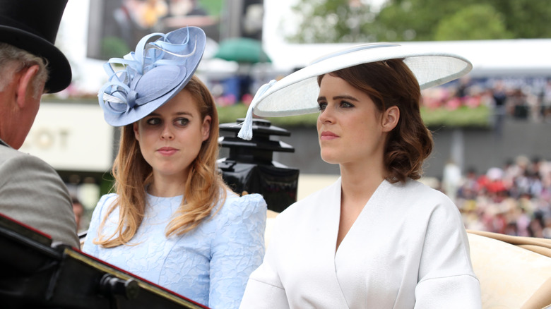 Princess Eugenie and Princess Beatrice sitting in a carriage