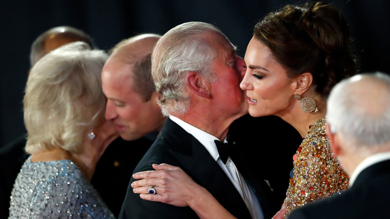 King Charles kissing Kate Middleton on the cheek