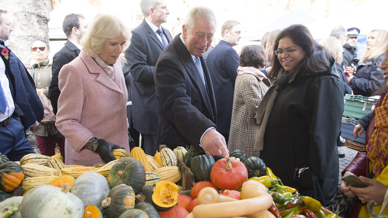 Camilla and Charles looking at vegetables