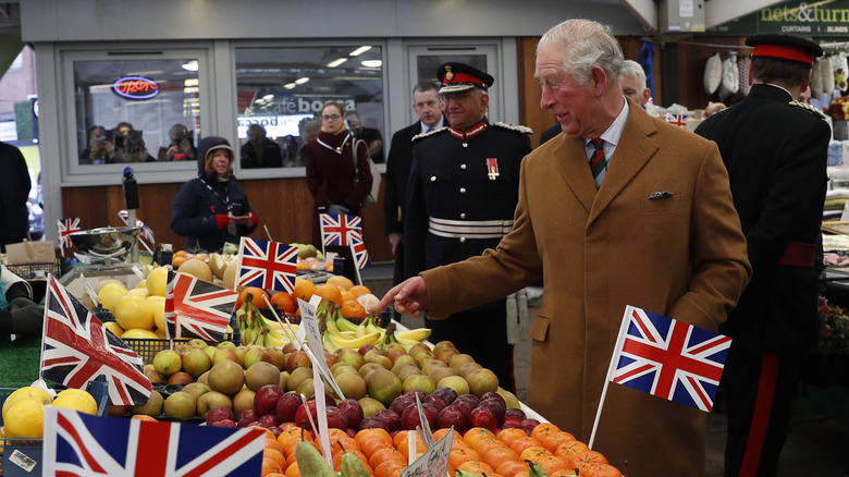 King Charles looking at fruit