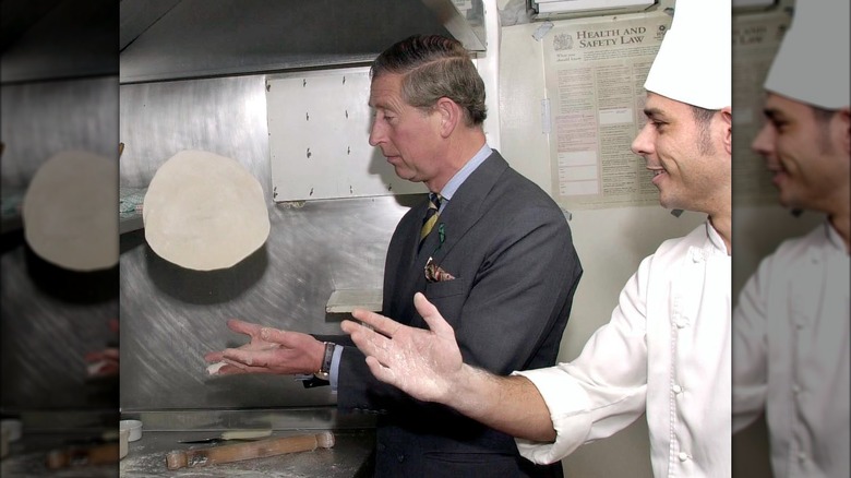 King Charles making pizza