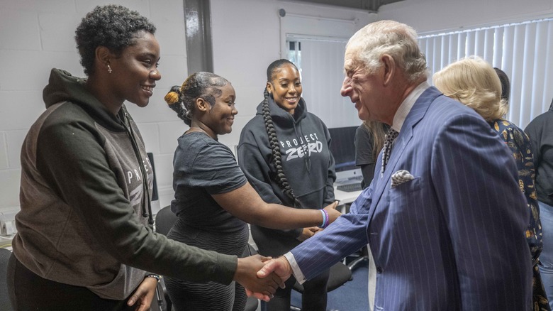 King Charles and Queen consort Camilla shaking hands