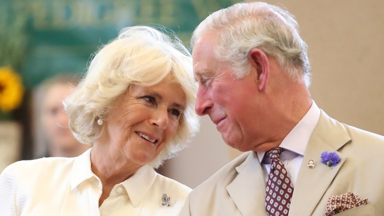 Queen Camilla smiling at King Charles