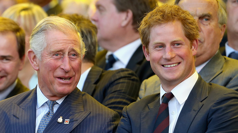 King Charles III and Prince Harry smiling