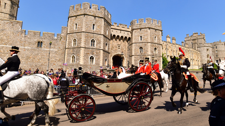 Prince Harry and Meghan Markle riding in a carriage