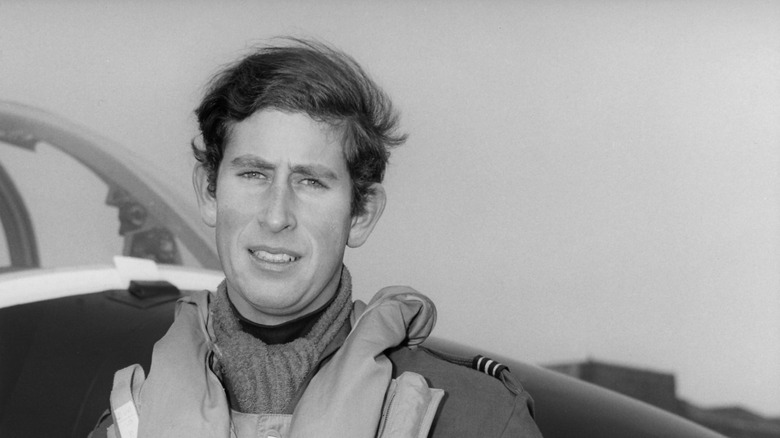 Prince Charles standing in front of jet plane