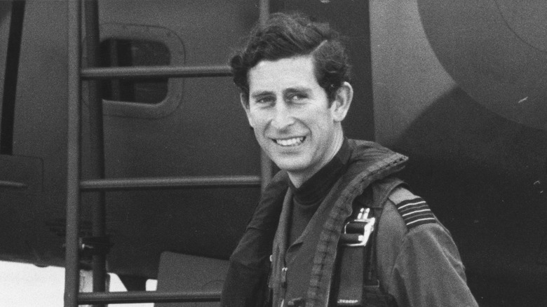 Prince Charles in front of an airplane