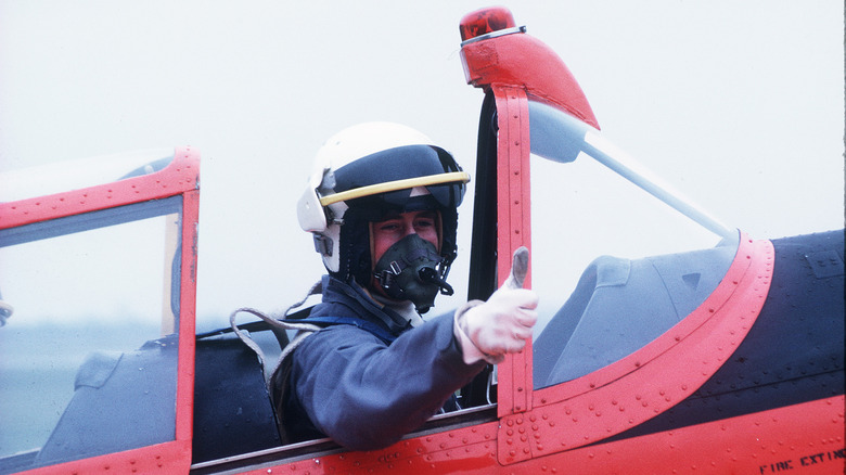 Prince Charles giving a thumbs-up in a plane