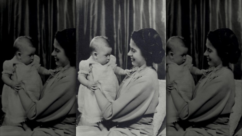 Queen Elizabeth holding Prince Charles as a baby