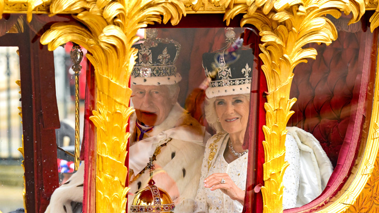 King Charles III and Queen Camilla in golden stage coach