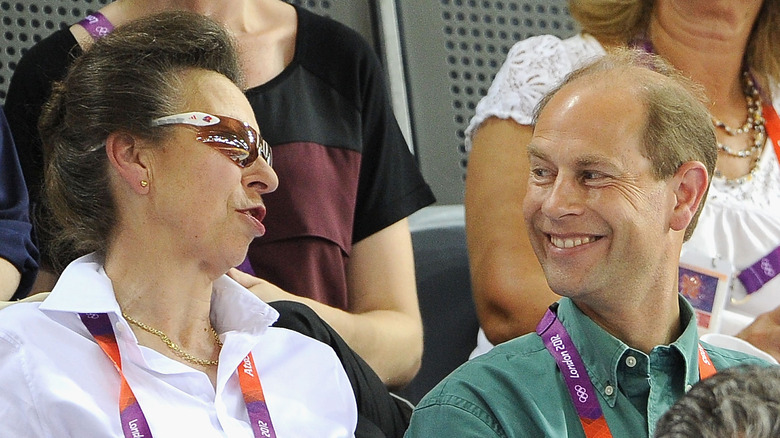 Princess Anne talking to a smiling Prince Edward