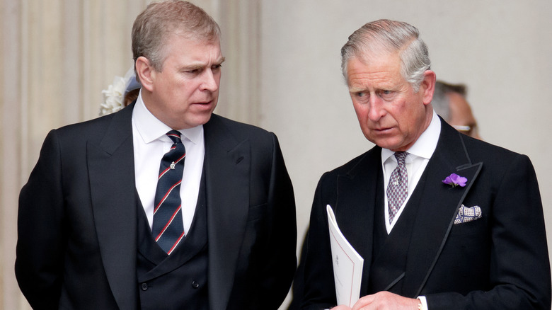 Prince Andrew looking at King Charles