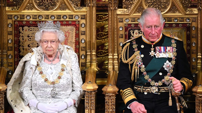 Queen Elizabeth II sitting next to King Charles III