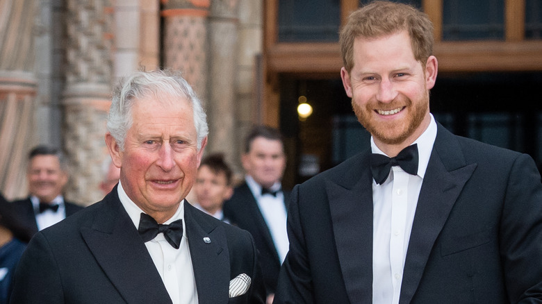 King Charles and Prince Harry posing in tuxedos