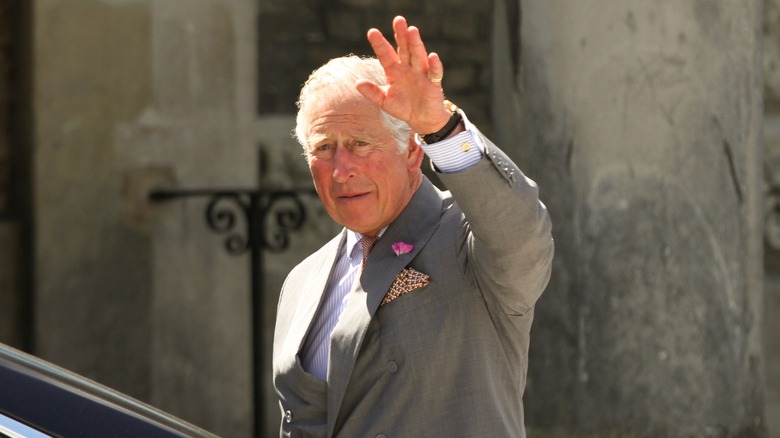 King Charles smiling and waving