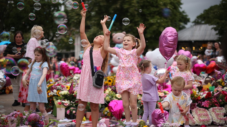 Children blowing bubbles at the Southport memorial