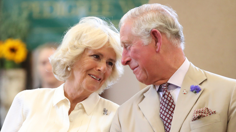 Queen Camilla smiling at King Charles