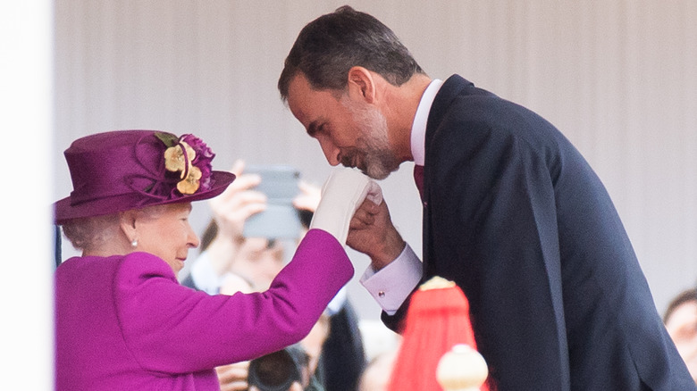 King Felipe of Spain kissing Queen Elizabeth's hand