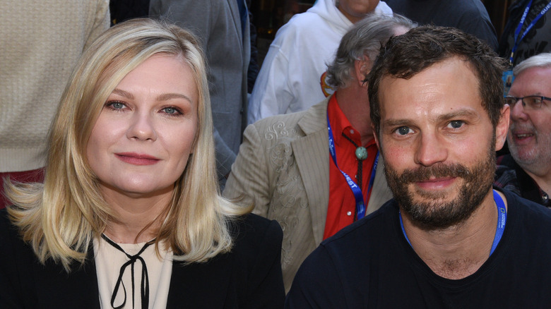 Kirsten Dunst and Jamie Dornan sitting together